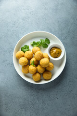 Homemade salmon croquettes with mustard