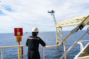 The bridge extends to release gas or a burning flame on an offshore platform.