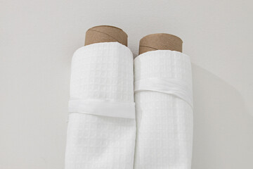 White cotton Fabric Rolls Mockup. Pieces of textile tied with ribbons. Towel