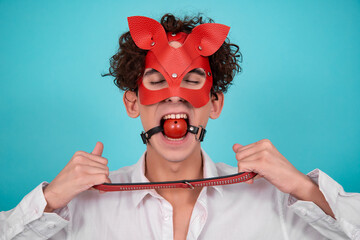 Adult games. Young attractive guy in a leather mask.