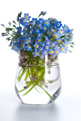 Bouquet of forget me not flowers in a crystal vase, created with Generative AI