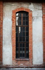 Red bricks around the windows of the old building, reflection on the windows