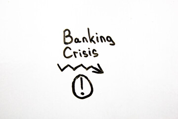 BANKING CRISIS business concept. Bank crisis text with down arrow.