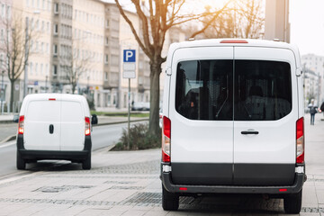 Small cargo delivery van parked in european city central district. Medium lorry minivan courier...