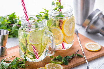 Refreshing lemon and lime lemonade with mint on a chalkboard.