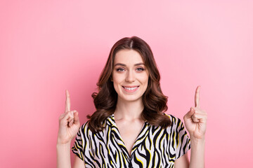 Photo of smiling promoter marketer girlish lady wear zebra style blouse direct fingers mockup cheap retro clothes isolated on pink color background