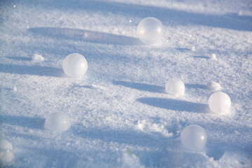 Soap bubbles in the snow, close-up, background.