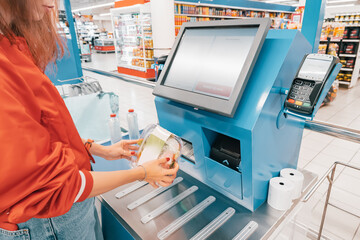 automated self-service checkout at the supermarket allows customers to quickly scan and pay for...