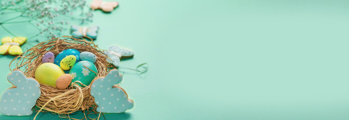 Easter banner on a green background. Bird's nest with Easter eggs. Happy Easter.