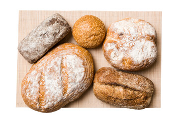 Freshly baked delicious french bread with napkin isolated on white background top view. Healthy white bread loaf