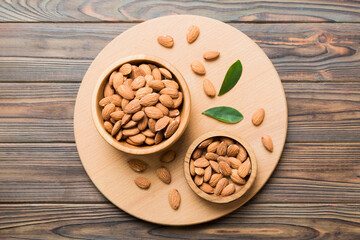 Fresh healthy Almond in bowl on colored table background. Top view