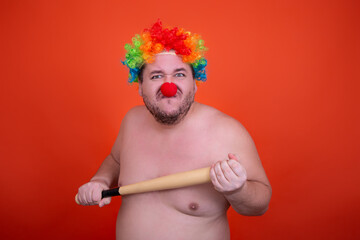 Funny fat man in a clown costume. Joy and anger.