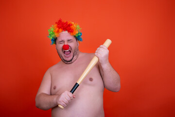 Funny fat man in a clown costume. Joy and anger.