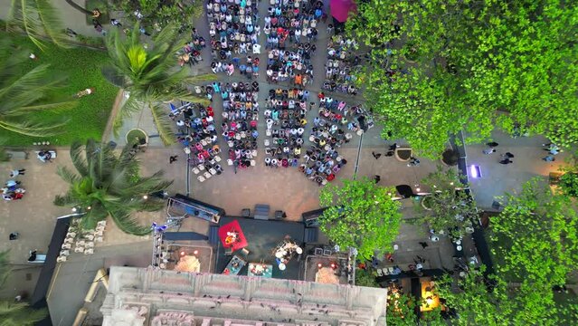 people are sitting and watching the program at  Dadar chow patty beach bird eye closeup to wide  view mumbai