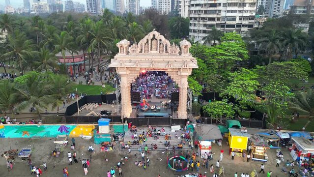 people are sitting and watching the program at  Dadar chow patty beach bird eye wide to closeup view mumbai