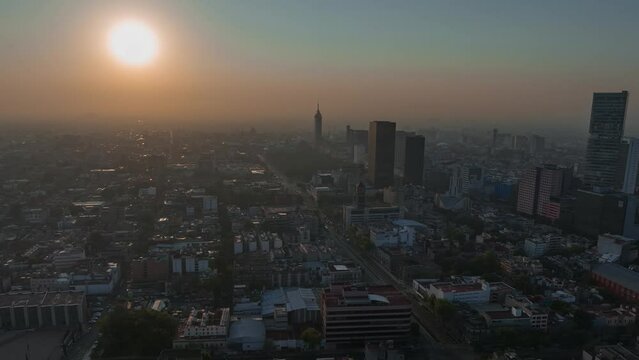 Beautiful aerial hyperlapse view of modern urban Mexico City, at sunset