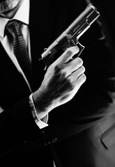 Naklejka premium Elegant man holding gun