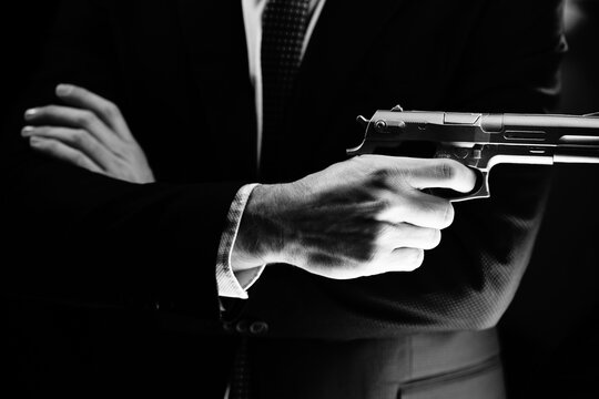 Elegant man holding gun