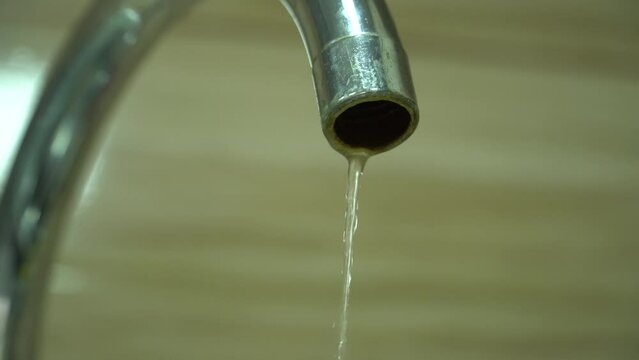 Water flowing from a faucet into a sink