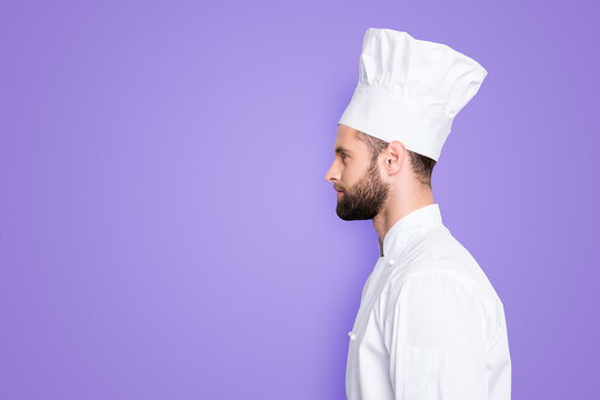 Profile side view half face portrait with copyspace empty place for advertisement product of concentrated, handsome chef cook in beret and white outfit isolated on grey background