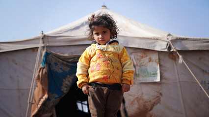 Portrait of refugee children living in the camp. The tragic humanitarian conditions of Syrian refugees