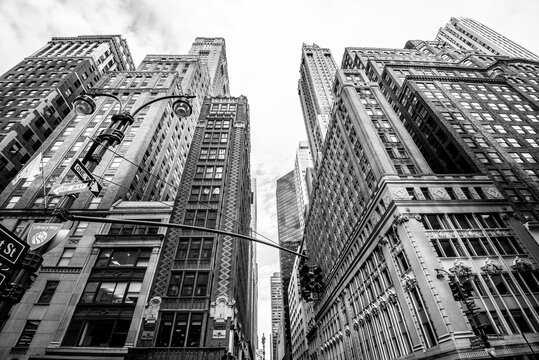 Fototapeta Manhattan street view with big buildings, New York, USA. Black and white