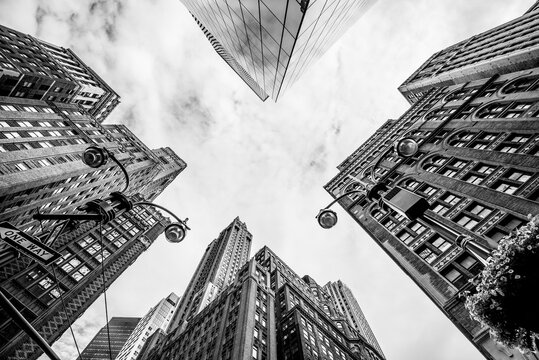 Fototapeta Manhattan street view with big buildings, New York, USA. Black and white