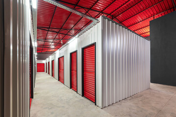 Corridor of self storage unit with red doors. Rental Storage Units