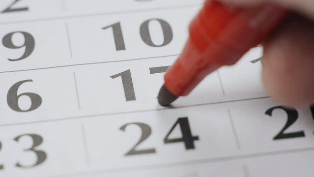 The seventeenth date on the calendar is boldly marked with a red marker as the day of the exam. Close-up.