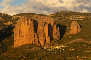 Famous climb walls mountains of Mallos de Riglos (Riglos cliffs) in Huesca and the Riglos village in the foreground.