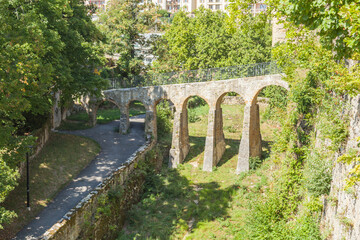 Fototapeta premium Part of the ancient fortress in Neuchatel city and pedestrian stone bridge. Canton Neuchatel, Switzerland