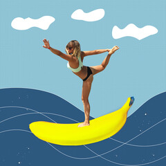 Young fit woman in swimwear and sunglasses riding a giant banana is like surfing the waves on...