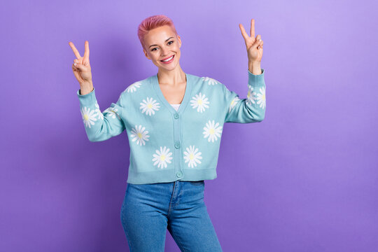 Photo of sweet friendly positive nice woman short hairstyle dressed blue cardigan showing v-sign isolated on purple color background