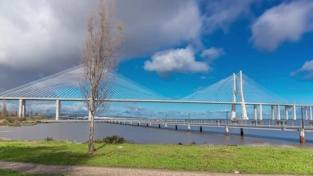 The Vasco da Gama Bridge timelapse hyperlapse with pier. Cable-stayed longest bridge flanked by viaducts and rangeviews that spans the Tagus River in Park of Nations in Lisbon, Portugal