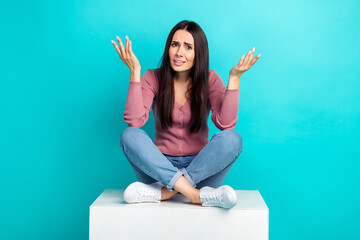 Full body length photo of hesitant lady shrug shoulders unhappy questioned what happened sit white platform isolated on cyan color background - obrazy, fototapety, plakaty