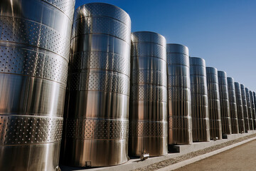 Steel modern cisterns for wine production on plant territory. Large tanks