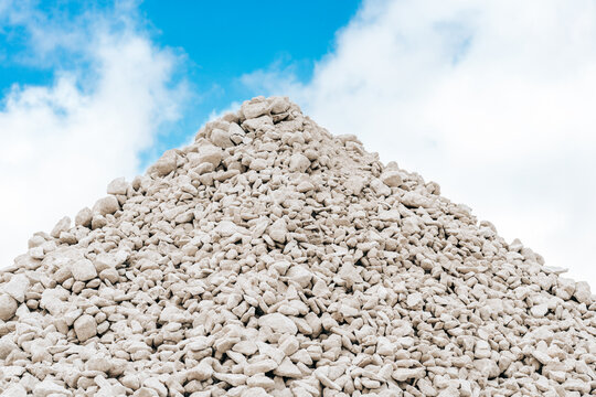 Sorted limestone rock in embankment. Open pit mining quarry. Geology concept.