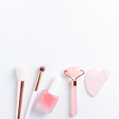 Cosmetics and self care flat lay with blank space. Beauty products arranged on white background, top view.