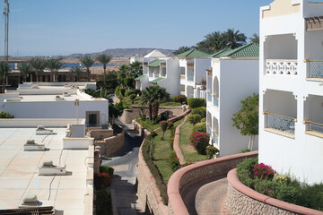 Palm trees against white home by the beach with blue sky and sand The top of the house or apartment with nice window