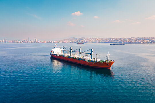 Bulk carrier or bulker anchored nearby port waiting uploading, Aerial wide shot
