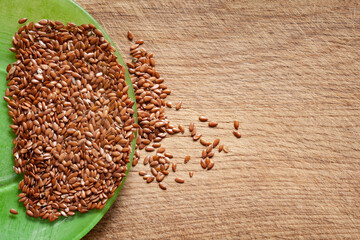 Flax seeds. Flax in a green bowl on a wooden board. Omega 3. Healthy nutrition