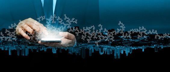 Business person holding smart phone with light screen on the background of city. Communication, technology,  IoT, internet, global, network, futuristic concept