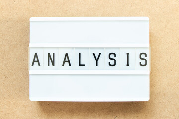 Lightbox with word analysis on wood background