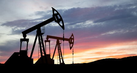 Oil drilling derricks at desert oilfield. The change in oil prices caused by the war. Oil price cap...