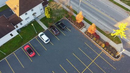 Aerial view parking lots of local business building with colorful autumn leaves along Five Mile Line Street, small town Penfield, County of Monroe, Upstate New York, USA