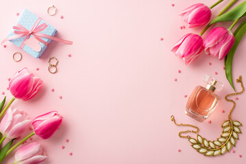 Mother's Day concept. Top view photo of pink tulips small blue giftbox perfume bottle jewelry gold rings necklace and sprinkles on isolated pastel pink background with empty space