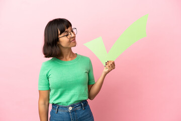 Youing woman holding a check icon with happy expression
