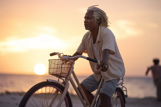 Mature Black Man With Gray Dreadlocks Hair Style Riding A Bike Near An Ocean Beach In California. Generative AI