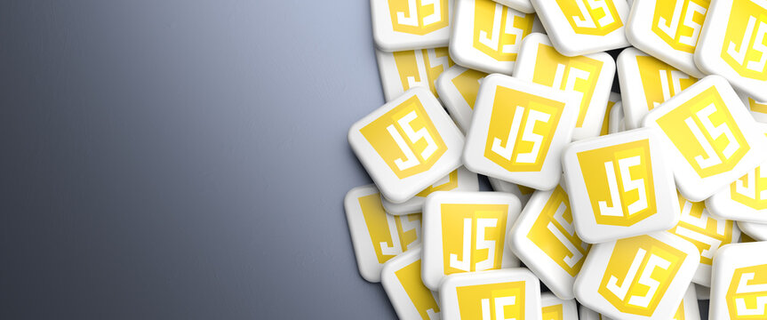 Logos of the programming language Javascript on a heap on a table. Web banner format, copy space