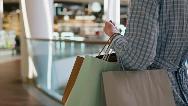 Sale, Stylish Woman In Mood Holds Paper Bags In A Fashion Boutique, In Slow Motion Modern Fashionista Spends Free Time In The Store To Update Her Wardrobe, Window Shopping.
